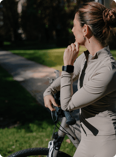 Person wearing the Hyfe CoughMonitor while biking in a natural environment