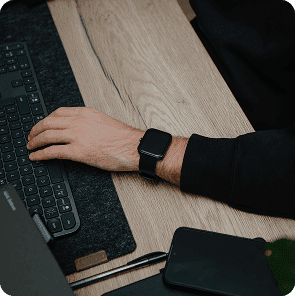 Researcher or user wearing the Hyfe CoughMonitor while working at a desk
